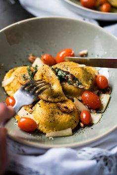 a person is cutting up some food on a plate with a knife and fork in it