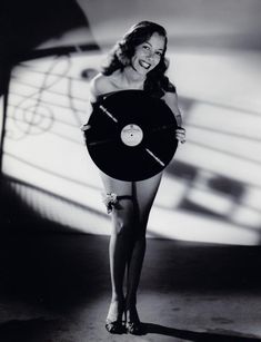 a woman is holding a record in her hands