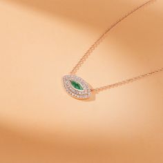 Gemma Embrace timeless elegance and symbolic protection with this stunning Emerald Diamond Evil Eye Necklace. A captivating marquise-cut emerald takes center stage, its vibrant green hue symbolizing growth, prosperity, and hope. The emerald is meticulously framed by two rows of sparkling pave diamonds, adding brilliance and enhancing the design's luxurious appeal. Expertly handcrafted by our skilled goldsmiths, this necklace is a perfect blend of craftsmanship, beauty, and symbolism. - Handmade- Fine Jewelry Green Marquise Necklaces, Marquise Diamond Necklace As A Gift, Marquise Emerald Jewelry In White Gold, Marquise Emerald Yellow Gold Jewelry, Marquise Emerald White Gold Jewelry, Elegant Green Marquise Necklace, Green Marquise Jewelry For May Birthstone, Marquise Emerald Jewelry For Gift, Marquise Emerald Jewelry Gift