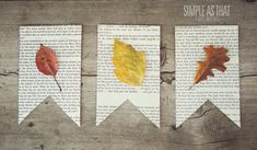 three bookmarks with leaves on them sitting on top of a wooden table next to each other