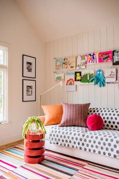 a living room filled with lots of furniture and pictures on the wall above it's couch