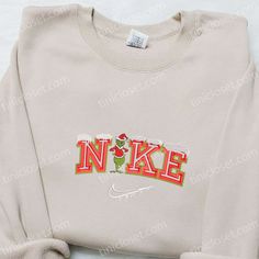 The Grinch Snow x Nike Embroidered Shirt is the perfect blend of style and holiday spirit. Made with high-quality materials, this shirt features an intricately embroidered Grinch design, adding a festive touch to any outfit. Its comfortable fit and durable construction ensure long-lasting wear. Give your loved ones the gift of warmth and style this Christmas with our Christmas Embroidered Sweatshirt. Crafted with care, this sweatshirt features a unique holiday-themed embroidery that will make a statement wherever you go. Made with soft and cozy fabric, it offers both comfort and style, making it an ideal gift for family members. Whether Nike Cartoon, Nike Inspired, Best Family Gifts, Maroon Hoodie, Hoodie Material, Custom Nikes, Nike Sweatshirts, Embroidered Clothes, Embroidered Sweatshirt