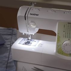 a white sewing machine sitting on top of a table