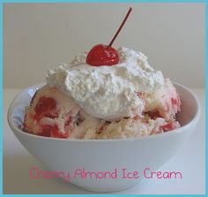 an ice cream sundae with cherries and whipped cream is in a white bowl