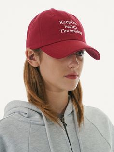 a woman wearing a red cap with the words keep on health and the holidays printed on it