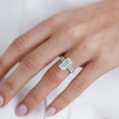 a woman's hand with a diamond ring on it