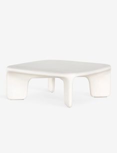 a white coffee table sitting on top of a white floor