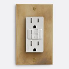 a white light switch sitting on top of a wooden wall mounted outlet with two outlets