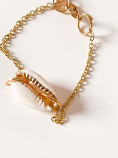 Bring in the essence of the ocean with the Seashell Chain Bracelet. Love the daintiness of the chain pairing well the delicate seashell. Easily wear this with a bracelet stack or on its own for a chic/elegant look.  - Seashell Pendant/ Charm  - Dainty Chain - Extra chain length with a clasp Elegant Shell-shaped Bracelet As A Gift, Dainty Adjustable Bracelet For Beach, Dainty Adjustable Chain Bracelet For Beach, Elegant Shell-shaped Bracelet Gift, Elegant Shell-shaped Bracelet, Dainty Adjustable Beach Bracelet, Dainty Bracelet With Adjustable Chain, Ocean-inspired Shell Bracelet Jewelry, Beach Jewelry With Adjustable Chain Bracelet