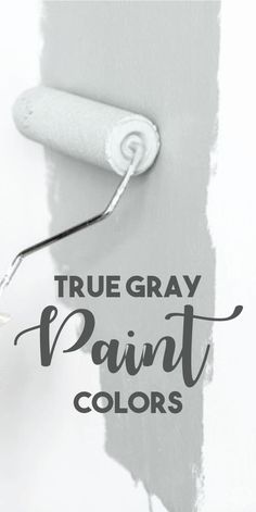 the words true gray paint colors are painted on a white wall with a black brush