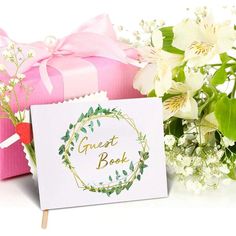 there is a card with the words great book on it next to flowers and a gift box