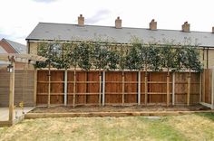 a wooden fence in front of a house