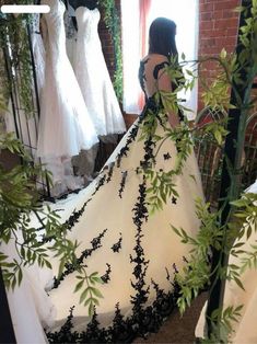 there is a woman that is looking at her wedding dress