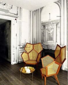 three wicker chairs sitting on top of a hard wood floor