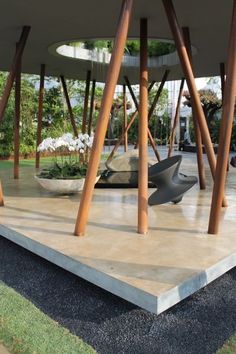 an outdoor area with wooden poles and sculptures