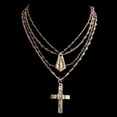 This artisan made cross is hand cast from a relic found in the Pyrennes Mountains of Southern France. The center of the necklace is graced with a Miraculous Medal featuring our Lady of Graces creating a spectacular showering of graces on four strands of Smokey Topaz Diamond Crystals. The strands are made from two size beads for comfort and are 4mm and 6mm. IIt can also be worn long by simply dropping one or two strands and meets in the back with a decorative toggle clasp. History: The Miraculous Handmade Bronze Cross Pendant Necklace, Handmade Bronze Necklace With Cross Pendant, Bronze Cross Bohemian Necklace, Bronze Bohemian Cross Necklace, Bohemian Bronze Cross Necklace, Bronze Crucifix Necklace As Gift, Bronze Crucifix Necklace For Spiritual Purposes, Bronze Crucifix Necklace For Gift, Spiritual Bronze Crucifix Necklace