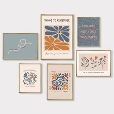 six framed art prints with different sayings and flowers on the front, two are blue, one is orange