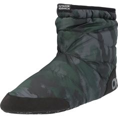 a pair of black and green boots with camouflage print on the bottom, side view