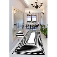 a black and white area rug in the middle of a room