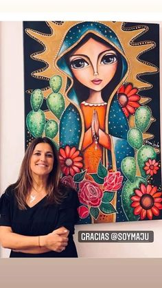 a woman standing in front of a painting on the wall with her arms folded out