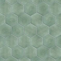 a green tiled wall with hexagonal tiles