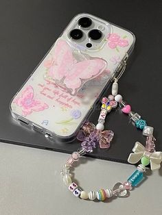 a cell phone case sitting on top of a table next to a beaded bracelet