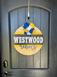 a door with a sign that says westwood high school hanging on the front door