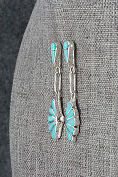 These beautiful turquoise and sterling silver earrings were made by Zuni silversmith Velda Nastacio. The backs are signed.Length: 1 3/4"Width: 1/2"Free shipping on all orders! We ship with USPS and always include tracking. All orders ship within a day of payment.Returns are accepted up to 30 days after you receive your order. Just send us a message. Our shop offers cash back or store credit. The item must be returned in new condition. Hallmarked Turquoise Sterling Silver Earrings, Western Style Nickel-free Turquoise Earrings, Artsy Turquoise Nickel-free Earrings, Turquoise Southwestern Nickel-free Hoop Earrings, Turquoise Nickel-free Southwestern Earrings, One-of-a-kind Southwestern Turquoise Jewelry, Bear Carving, Pearl Chain, Native American Jewelry