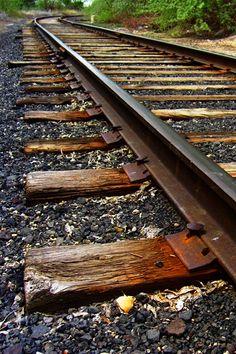 an old train track with some wood on it