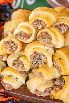 a pile of sausage and cream cheese crescents on a platter with text overlay