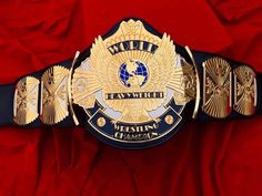 a belt that is on top of a red cloth with the words world law watch