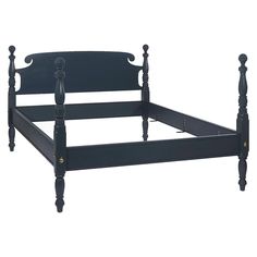 a black bed frame with wooden posts and headboard