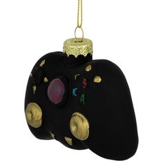 a black and gold decorated ornament hanging from a chain