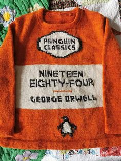 an orange sweater with the words penguin classics written on it