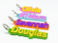 three keychains with different colored letters on them