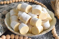 a bowl filled with sugar covered cookies on top of a table