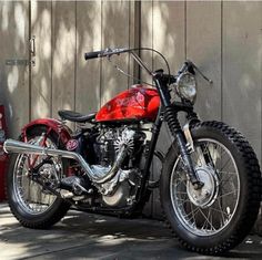 a red motorcycle parked next to a building