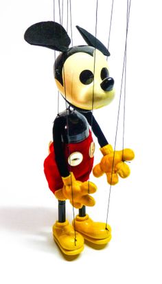 a mickey mouse figurine hanging from strings