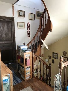 a staircase with bookshelves and pictures on the wall