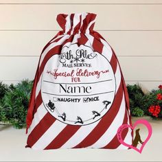 a red and white striped bag sitting on top of a table next to christmas decorations