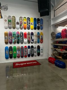 there are many skateboards hanging on the wall