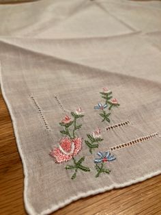 the table cloth has flowers embroidered on it