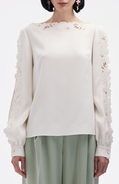 Intricate broderie anglaise details the bateau neck and open sleeves of this popover top crafted from stretch silk. Bateau neck Long sleeves with button cuffs Silk/elastane Dry clean Imported Designer Clothing Elegant Embroidered Sleeve Top For Work, Elegant Tops With Embroidered Sleeves For Work, Elegant White Long Sleeve Top For Spring, Feminine Silk Tops With Sheer Sleeves, Feminine Silk Top With Sheer Sleeves, Elegant Crew Neck Lace Top With Lace Trim, Elegant Crew Neck Blouse For Formal Occasions, Elegant Long Sleeve Top With Sheer Sleeves, Elegant White Tops With Lace Sleeves