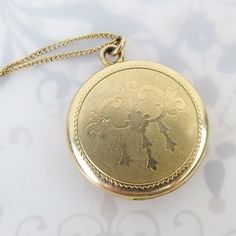 "R&G Co. (est. 1915, Attleboro, MA) made this round vintage gold filled \"LaMode\" brand engraved locket. The front has a subtle smooth chandelier style image with a stippled matte finish. The back has a spiral turned design. The locket opens with a small fingernail groove near the top and closes securely with a snap. Inside you will find both original rose gold hue frames and inserts.  One side is signed, \"LaMode\" (line attributed to R&G Co circa 1934). It is also marked \"1/20\" (gold filled Vintage 14k Gold Locket Necklace, Vintage 14k Gold Locket Necklace Stamped 14k, Gold Medallion Locket Necklace Stamped 14k, Antique Medallion Locket Necklace Stamped 14k, Victorian Round Locket Necklace Stamped 14k, Vintage 14k Gold Locket Jewelry, Victorian Filigree Locket Necklace In Yellow Gold, Victorian Yellow Gold Locket Necklace With Filigree, Victorian Filigree Yellow Gold Locket Necklace