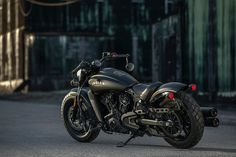 a black motorcycle parked in front of a building