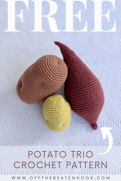 two crocheted fish sitting next to each other on top of a white surface