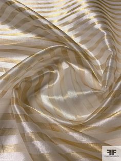 an image of a white and gold striped material that looks like fabric or something with stripes on it