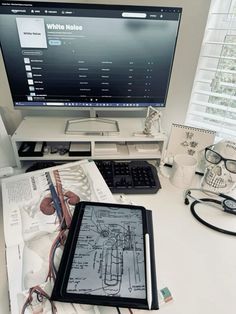 a tablet computer sitting on top of a white desk