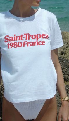 Catch those retro summer vibes with our 'Saint-Tropez 1980 France' tee! Perfect for adding a splash of vintage French chic to your beach adventures! Unisex soft cotton crew neck t-shirt featuring a red Saint Tropez 1980 France graphic printed on the front. Fabrics: 100% cotton, 6.1 oz Made in: LA French Riviera Style, T Shirt Aesthetic, Graphic Tee Outfits, Retro Graphic Tees, Beach Adventure, Holiday Tops, Graphic Tees Vintage, Retro Summer, Cool Graphic Tees