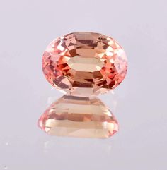 AAA Flawless 10 x 14 mm Natural Ceylon Peach Padparadscha Sapphire Loose Oval Cut 18.05 Ct Gemstone Ring And Jewelry Making GIT Certified GEMSTONE SPECIFICATION :- TOTAL CARAT WEIGHT = 18.05 CT LENGTH = 10.00 MM WIDTH = 14.00 MM DEPTH = 9.20 MM DIMENSION = 10.00 x 14.00 x 9.20 MM PRODUCT DETAILS THEY ARE SYMBOLIC. FOR THE MOST PART, THE PEACH PADPARADSCHA SAPPHIRE IS USED TO SYMBOLIZE OPEN COMMUNICATION AND CLARITY OF THOUGHT. APART FROM THIS, THE STONE IS ALSO ASSOCIATED WITH LOVE, TRUTH, FAITH Peach Sapphire, Padparadscha Sapphire, Black Spot, Sapphire Gemstone, Oval Cut, Blue Sapphire, Tourmaline, Topaz, Sapphire